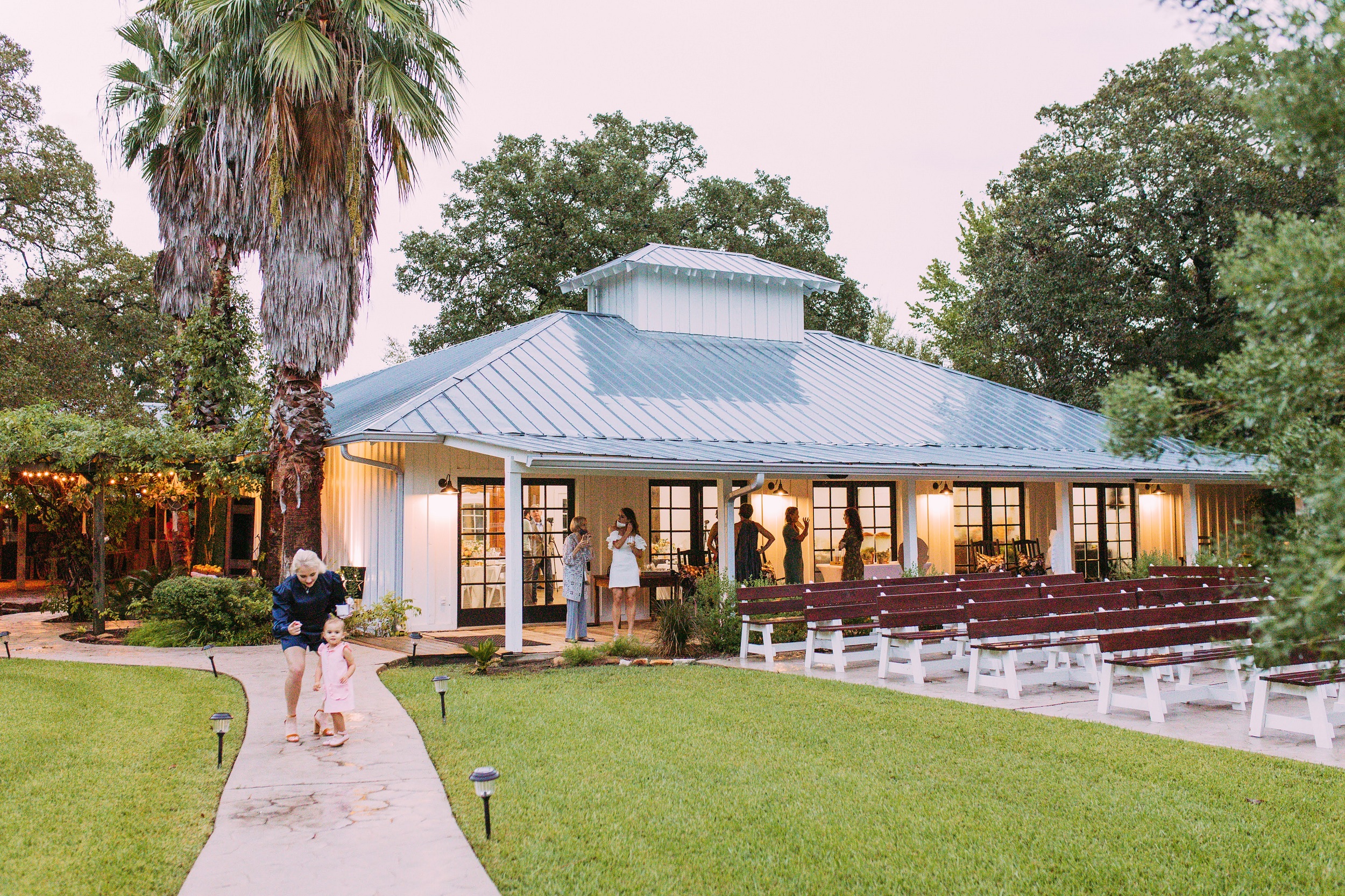 View of Covered Pavilion at dusk with light evenly lighting up accents of 7F Lodge's banquet room - Wedding Venue in Houston